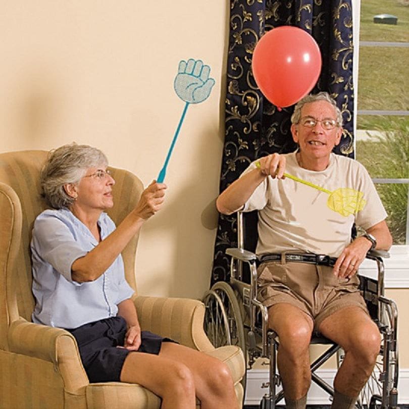 Two elderly people playing Balloon Swatters game